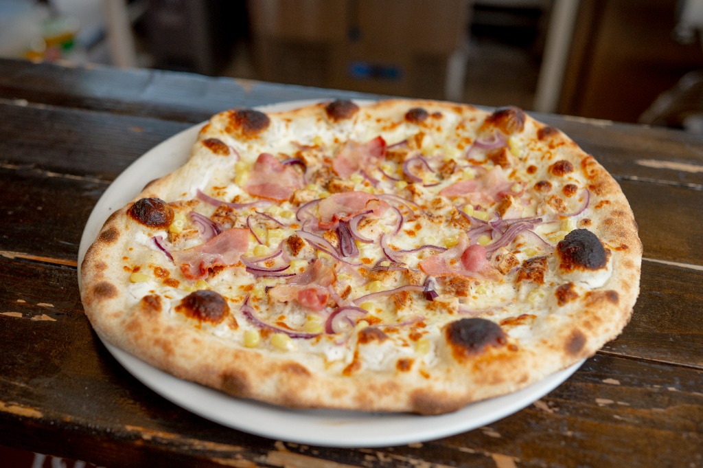 Kemencés pizza tejfölös alappal, baconnel, lilahagymával és kukoricával